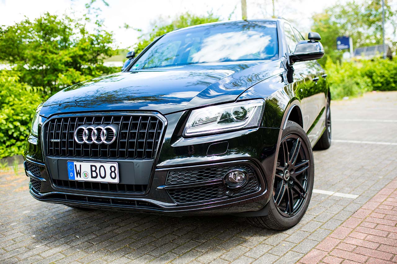 front of a black audi